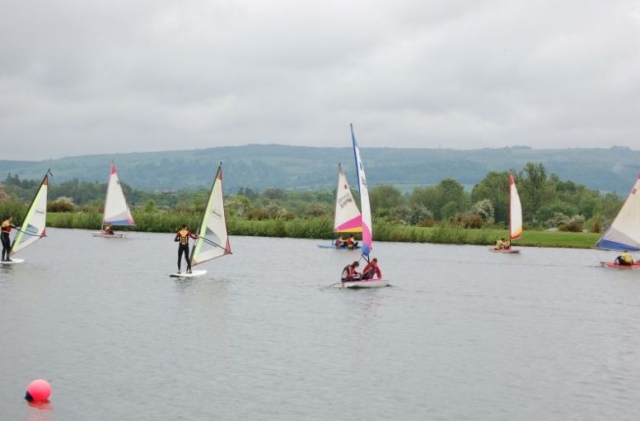 Sailers and windsurfers sharing the lake